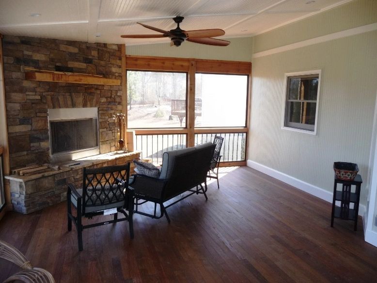 outdoor fireplace inside a screen porch