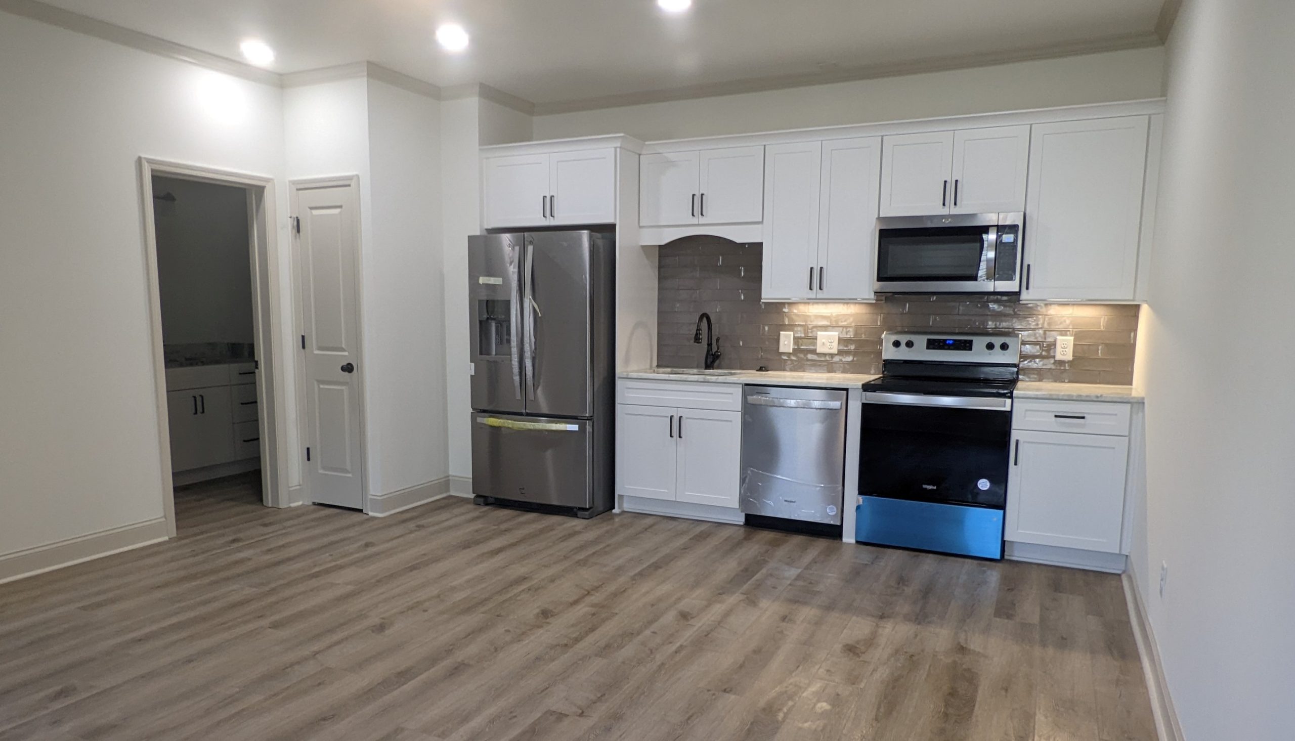 white cabinets with subway tile backsplash